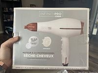Front of box showing Infinit Pro Conair hair dryer image and main features like no-slip grip, diffuser, and ceramic technology.