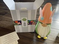 Photo showing the Easter gnome warmer out of the box with original packaging and instructions.