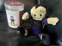 Frankenstein Scentsy Buddy Clip plush figure and its container shown new in package.