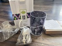 View of the nativity-themed Scentsy warmer with cord, manual, and original box.
