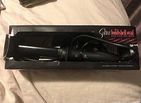 Sultra The Bombshell Oval Rod Curling Iron in black inside original black box.