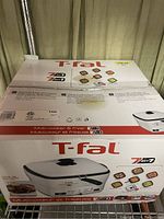 Photo of factory sealed T-fal 7-in-1 multi-cooker air fryer box with product image and features.