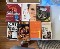 Seven books arranged on a flat surface showing titles and covers.