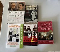 Photo showing five books laid out on a white surface. Titles visible include Roosevelt and Stalin, Vonnegut in America, Stories from Puerto Rico, Ordinary Men, and The Post-American World.