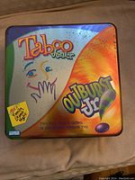 Metal tin game box featuring Taboo Junior and Outburst Jr. games