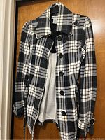 Front view of Self Esteem blue, black, and white checkered juniors jacket size L, long sleeves, button closure, with visible stain near lower button.