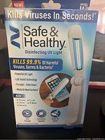 Front packaging showing product name, UV light disinfecting claims, and benefits including kills 99.9% viruses and bacteria, portable and folds down.