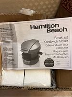 Hamilton Beach Breakfast Sandwich Maker box showing product image, name, and recipe languages.