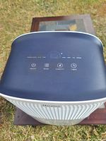 Top view of Vacplus dehumidifier control panel showing On/Off, Mode, Humidity, and Timer buttons on a black surface with white body.