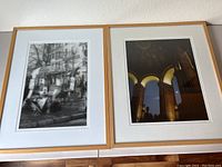 Pair of framed David A Hart Paris scene photographs hanging on a wall.