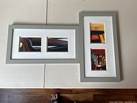 Two framed prints placed on a white surface showing the full view. One frame is horizontal with two abstract images. The other is vertical with floral and abstract images.