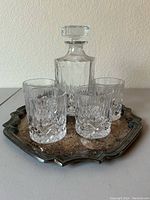 Full set front view on the vintage metal tray showing decanter and four glasses.