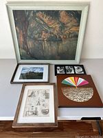 Overview of all framed art pieces on table showing size comparison and variety