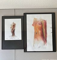 Framed Robert Lackney nude torso and Maumee Bay art prints, showing visible signatures and inscriptions.
