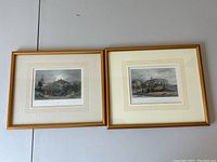 Two framed antique engraving prints depicting Rye and Hastings in Sussex, placed side by side on a flat surface showing overall condition and framing.
