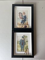 Two black shadow box frames displayed side by side showing the vintage paper roll illustrations within.
