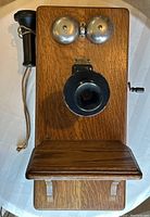 Front view of oak box telephone showing bells, mouthpiece and earpiece