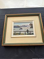 Overall frontal view of framed painting on black background