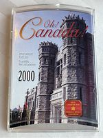 Front cover of the coin set showing 'Oh! Canada!' title and Royal Canadian Mint logo with a stone building background.