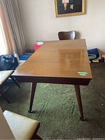 Front-angle view of full table showing tabletop and tapered legs