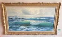 Full view of one framed ocean wave painting with ornate gold frame