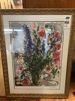 Full view of the framed lithograph titled Les Lupins Bleu showing the floral artwork with figures, framed in a gold-tone ornamental frame.