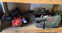 Photo of Craftsman chainsaw and Black & Decker sander on shelf