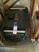 Angled top-down view showing the Predator logo on the front, top-mounted fuel cap, and silver handle bars