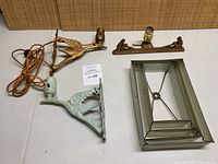 Overview of two bird wall sconces, decorative lamp body with female figures, and MCM metal/glass lamp shade.