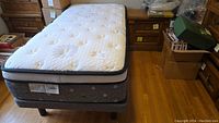 Full view of twin mattress on matching bed base in room setting