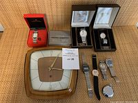 Overview of Art Deco wall clock alongside boxed and loose watches