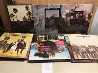Photo showing a collection of vintage rock vinyl LP albums including Eagles, Steppenwolf, Pilot, Doobie Brothers, and others.