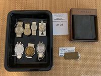 Overview of wallet, brass clip and seven coin motif clips on tray with lot tag