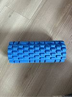 Top down view of blue foam exercise roller showing textured pattern for muscle massage.