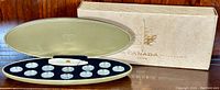 The full Millennium coin set in a gold oval display case accompanied by the original outer cardboard box with Royal Canadian Mint logo.