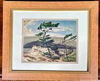 Framed art print showing entire piece with natural wood frame and double matting, image of pine trees on rocky landscape