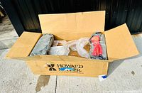 Box containing the original packaging for the clock with protective padding visible.