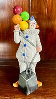 Front view of the Royal Doulton Balloon Clown figurine standing on a shelf.