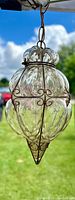Full front view of the Venetian bubble glass lantern hanging outdoors under daylight, showing the wire cage and glass details.