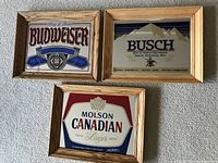 Three wood-framed beer mirrors featuring Budweiser, Busch, and Molson Canadian logos