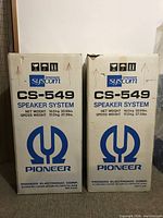 Two original white product boxes labeled 'Pioneer Syscom CS-549 Speaker System' placed side by side.