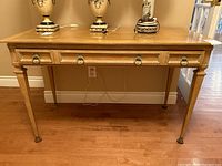 Front view of desk showing top surface, drawer and legs