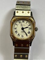Front view of watch showing rectangular case, bezel, dial and top of bracelet
