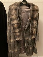 Front view of the Jordan Livingston ladies fur coat hanging on an Elite Furs hanger, showing texture and length