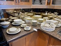Full view of entire Heinrich Selb Bavaria dinnerware set including plates, bowls, cups and serving pieces on countertop