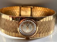 Front view of watch face and honeycomb patterned bracelet