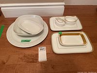 Full view of all dishes showing a large plate, smaller bowls, two rectangular serving platters and sugar and creamer set