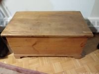 Front and top view of antique pine chest showing rectangular shape, wooden texture, and beveled edges.