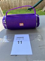 Front view of the purple Bluetooth speaker showing the T&G logo and carrying handle.