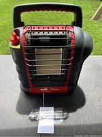 Front view of Mr. Buddy portable propane heater showing safety grille and ceramic heating element with control knob on side and carrying handle on top.